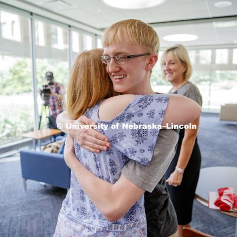 Sam Harvey receives a hug from his mom, Elisia Flaherty, after receiving a full ride scholarship offer the university presented by Executive Vice Chancellor Donde Plowman. Sam is a high school junior from Grand Island and scored a perfect ACT score. June
