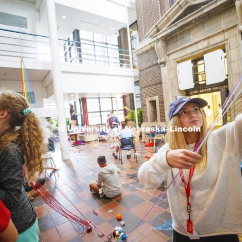 High School summer camp students in Architecture make string designs in the Link of Architecture Hall. June 21, 2018. Photo by Craig Chandler / University Communication.