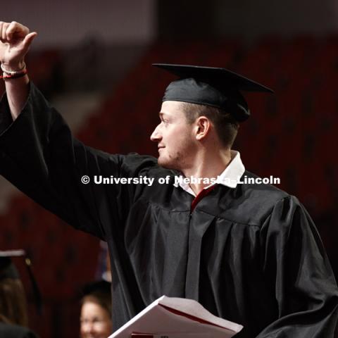Robert Dohn gives his friends and family and thumbs up after receiving his diploma. Summer Commencement at Pinnacle Bank Arena. August 11, 2018. Photo by Craig Chandler / University Communication.