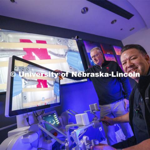 Nebraska Engineering professor and Virtual Incision co-founder Shane Farritor watches as Dr. Michael Jobst, a colorectal surgery specialist in Lincoln, makes the first surgical robotic cut on the International Space Station. Using controls at the Virtual Incision offices in Lincoln, surgeons cut rubber bands — mimicking surgery inside a payload box on the International Space Station. February 10, 2024. Photo by Craig Chandler / University Communication and Marketing.