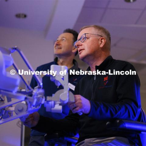 Nebraska Engineering professor and Virtual Incision founder Shane Farritor takes a turn using the surgical robot as Dr. Dmitry Oleynikov watches. Virtual Incision successfully performed robotic surgery on the International Space Station. Controlled from the Virtual Incision offices in Lincoln, NE, surgeons cut rubber bands–mimicking surgery–inside a payload box on the International Space Station. February 10, 2024. Photo by Craig Chandler / University Communication and Marketing.