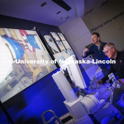 Nebraska Engineering professor and Virtual Incision founder Shane Farritor takes a turn using the surgical robot as Dr. Dmitry Oleynikov mimics the robot’s arm motions. Virtual Incision successfully performed robotic surgery on the International Space Station. Controlled from the Virtual Incision offices in Lincoln, NE, surgeons cut rubber bands–mimicking surgery–inside a payload box on the International Space Station. February 10, 2024. Photo by Craig Chandler / University Communication and Marketing.