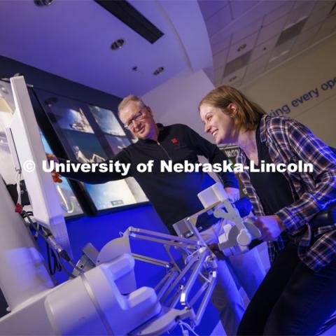Rachael Wagner, a Husker doctoral student, gets a chance at surgically cutting a rubber band on the International Space Station as Nebraska Engineering professor and Virtual Incision founder Shane Farritor looks on. Virtual Incision successfully performed robotic surgery on the International Space Station. Controlled from the Virtual Incision offices in Lincoln, NE, surgeons cut rubber bands–mimicking surgery–inside a payload box on the International Space Station. February 10, 2024. Photo by Craig Chandler / University Communication and Marketing.