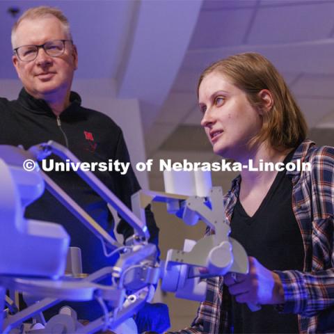 Rachael Wagner, a Husker doctoral student, gets a chance at surgically cutting a rubber band on the International Space Station as Nebraska Engineering professor and Virtual Incision founder Shane Farritor looks on. Virtual Incision successfully performed robotic surgery on the International Space Station. Controlled from the Virtual Incision offices in Lincoln, NE, surgeons cut rubber bands–mimicking surgery–inside a payload box on the International Space Station. February 10, 2024. Photo by Craig Chandler / University Communication and Marketing.