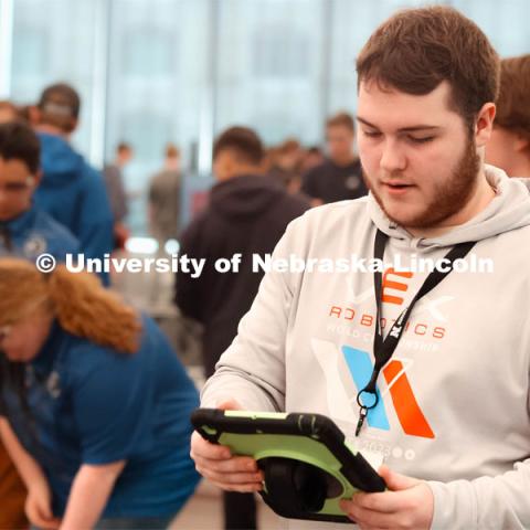 First Year UNL student from Omaha, NE, Cale Siegerson helps keep score. 2024 VEX Robotics Outreach Tournament hosted in Kiewit Hall. February 10, 2024. Photo by Taryn Hamill for University Communication and Marketing.