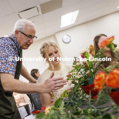 Professor Stacy Adams talks with Maddie Lind about adding to the symmetry of her bouquet. Adams teaches PLAS 261 - Floral Design I in the Plant Science Building on East Campus. February 14, 2024. Photo by Craig Chandler / University Communication and Marketing.