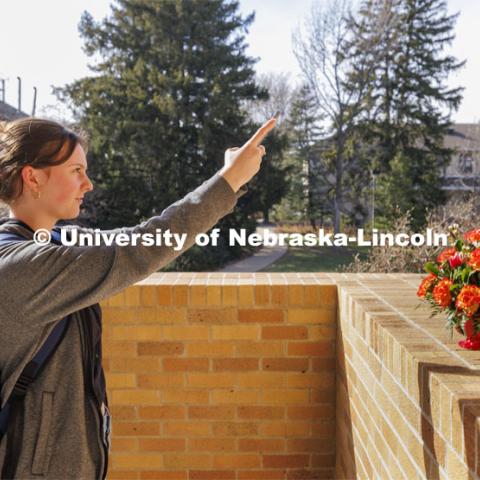 Chloe Waller takes a photo of her bouquet outside of the Plant Science Building after class.  Adams teaches PLAS 261 - Floral Design I in the Plant Science Building. February 14, 2024. Photo by Craig Chandler / University Communication and Marketing.