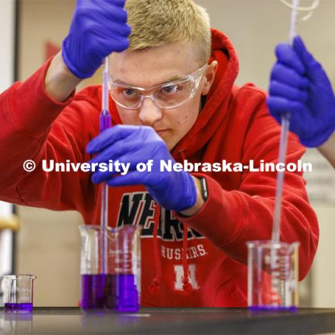 Brecken Krueger draws up crystal violet for a lab entitled “kinetics at work”. Hamilton Hall chemistry 110 lab. February 29, 2024. Photo by Craig Chandler / University Communication and Marketing.