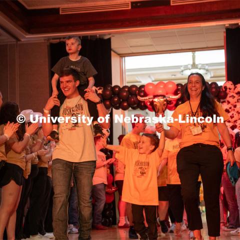 University of Nebraska-Lincoln student, Luke Woosley, enters with his miracle family at Dance Marathon. University of Nebraska–Lincoln students raised $83,702.24 during the annual HuskerThon. Also known as Dance Marathon, the event is part of a nationwide fundraiser supporting Children’s Miracle Network Hospitals. The annual event, which launched in 2006, is the largest student philanthropic event on campus. The mission of the event encourages participants to, “dance for those who can’t.” All funds collected by the Huskers benefit the Children’s Hospital and Medical Center in Omaha. March 2, 2024. Photo by Kirk Rangel.
