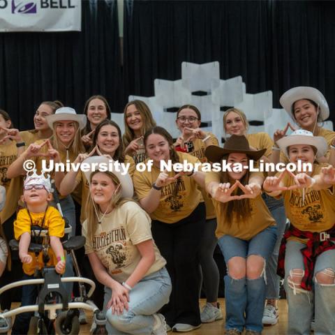 Members from Tri-Delta sorority pose for a photo with their sponsored miracle child at Dance Marathon. University of Nebraska–Lincoln students raised $83,702.24 during the annual HuskerThon. Also known as Dance Marathon, the event is part of a nationwide fundraiser supporting Children’s Miracle Network Hospitals. The annual event, which launched in 2006, is the largest student philanthropic event on campus. The mission of the event encourages participants to, “dance for those who can’t.” All funds collected by the Huskers benefit the Children’s Hospital and Medical Center in Omaha. March 2, 2024. Photo by Kirk Rangel.
