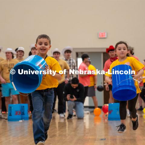 Dance Marathon miracle kids race to place a bucket in a game of tic-tac-toe. University of Nebraska–Lincoln students raised $83,702.24 during the annual HuskerThon. Also known as Dance Marathon, the event is part of a nationwide fundraiser supporting Children’s Miracle Network Hospitals. The annual event, which launched in 2006, is the largest student philanthropic event on campus. The mission of the event encourages participants to, “dance for those who can’t.” All funds collected by the Huskers benefit the Children’s Hospital and Medical Center in Omaha. March 2, 2024. Photo by Kirk Rangel.
