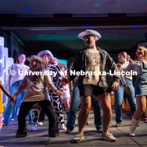 University of Nebraska-Lincoln students, Eli Hiser (center) and Ella Jepsen (right) lead a miracle kid in a new dance at Dance Marathon. University of Nebraska–Lincoln students raised $83,702.24 during the annual HuskerThon. Also known as Dance Marathon, the event is part of a nationwide fundraiser supporting Children’s Miracle Network Hospitals. The annual event, which launched in 2006, is the largest student philanthropic event on campus. The mission of the event encourages participants to, “dance for those who can’t.” All funds collected by the Huskers benefit the Children’s Hospital and Medical Center in Omaha. March 2, 2024. Photo by Kirk Rangel.