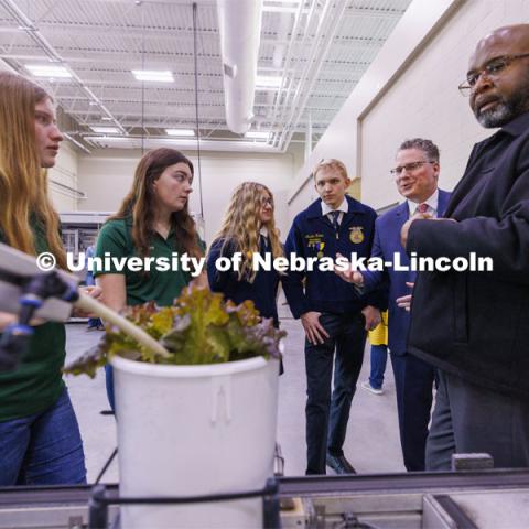 From left: Cassidy Marickle and Brook Brengelman, seniors from Boone Central High School, Johanna Roux and Austin Kamm, seniors from Lincoln Southwest, listen as Derek McLean, dean of the Agricultural Research Division and Chancellor Rodney Bennett explain the phenotyping facility at Nebraska Innovation Greenhouse. Governor Jim Pillen signed the Ag Week Proclamation at Nebraska Innovation Greenhouse Tuesday morning. March 20, 2024. Photo by Craig Chandler / University Communication and Marketing.