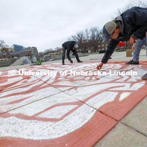 To welcome students for Admitted Student Day, designers Sam Sisco and Jesse Petersen chalk a mural onto the plaza outside the Nebraska Union. Admitted Student Day is UNL’s in-person, on-campus event for all admitted students. March 22, 2024. Photo by Craig Chandler / University Communication and Marketing.