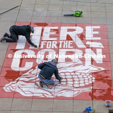 To welcome students for Admitted Student Day, designers Sam Sisco and Jesse Petersen chalk a mural onto the plaza outside the Nebraska Union. Admitted Student Day is UNL’s in-person, on-campus event for all admitted students. March 22, 2024. Photo by Craig Chandler / University Communication and Marketing.